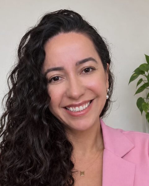 Dany Zumer, case manager, smiling, in a pink blazer.